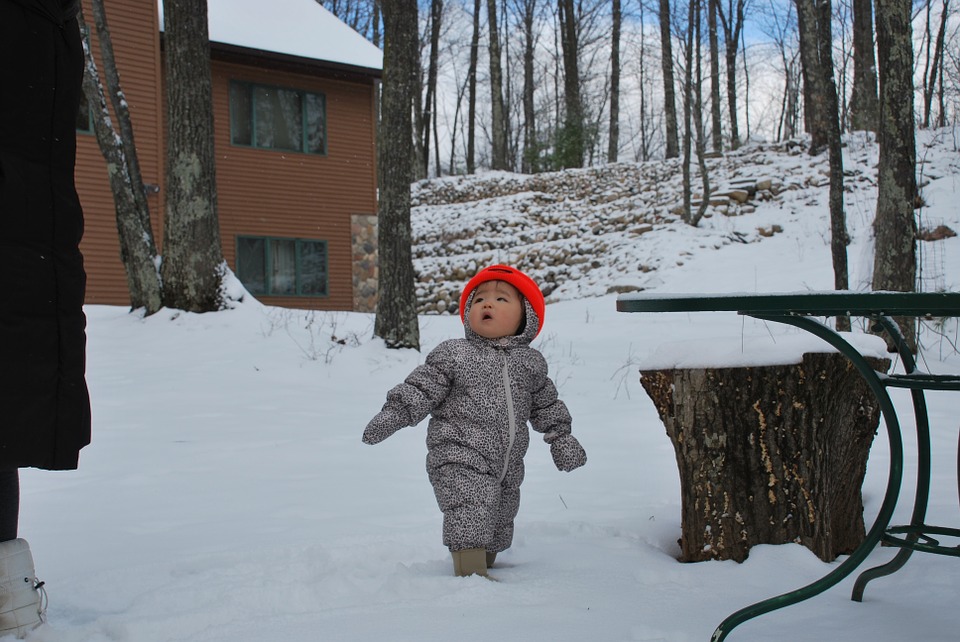 Image of a baby in a snowsuit outside