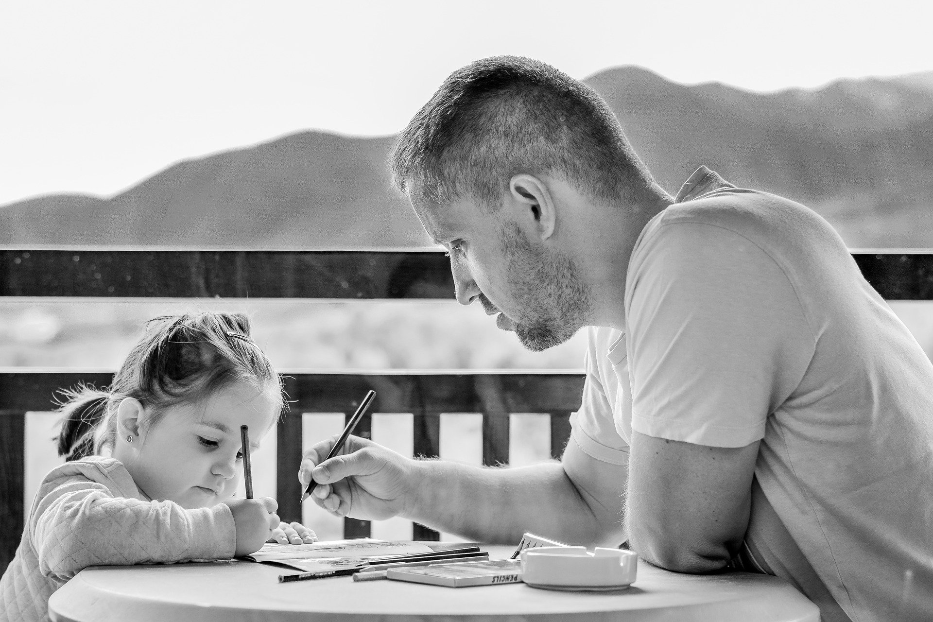 Dad and daughter writing together