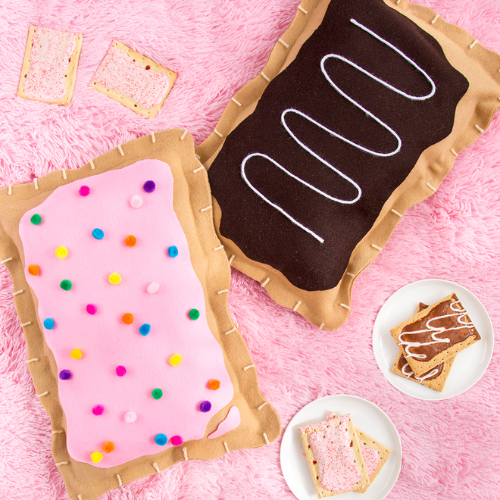Pink background with Pop Tarts (chocolate with white swirls and pink with sprinkles)