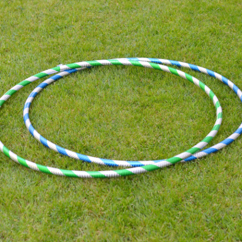 Two blue and white hula hoops on the grass