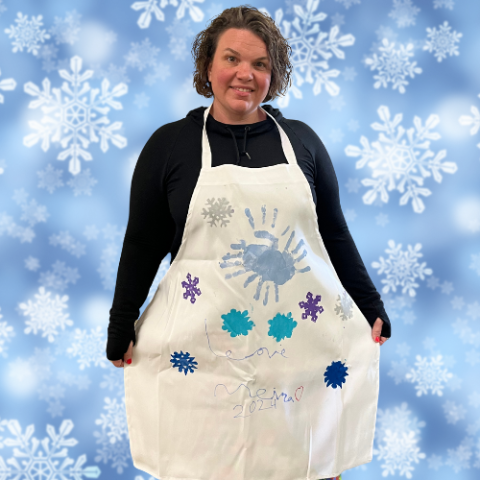 Make a Gift Apron modeled by Ms. Dani and stamped with handprints and snowflakes