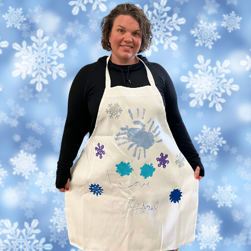 Make a Gift Apron modeled by Ms. Dani and stamped with handprints and snowflakes